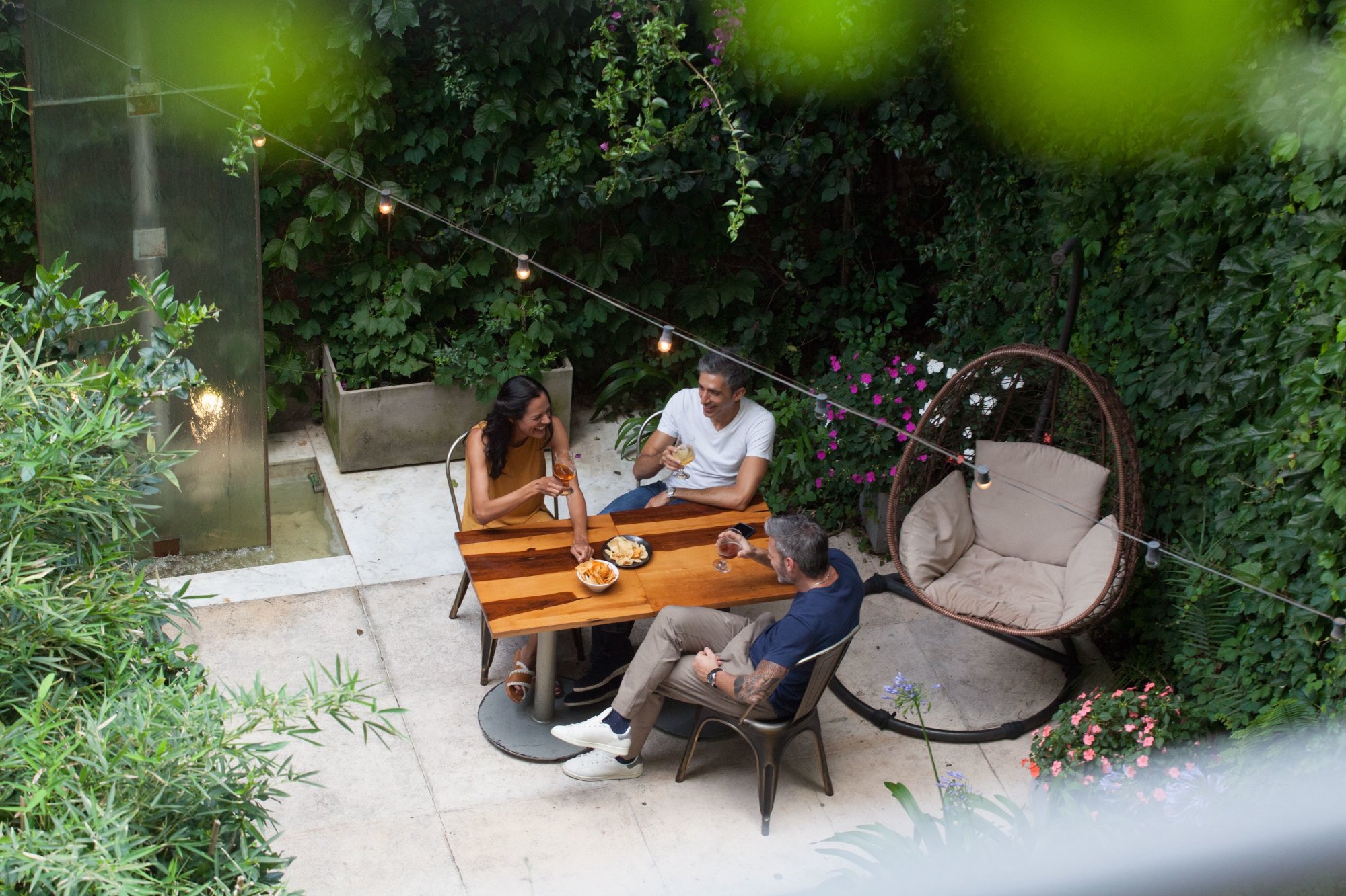 Grupo de amigos disfrutando en el jardín del hotel Palo Santo en Palermo Buenos Aires